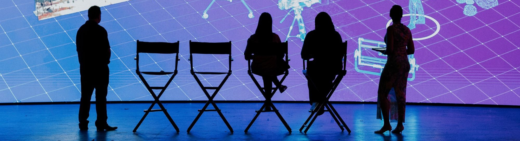 Ashley Nicole Singleton hosting a panel in silhouette on a virtual production stage