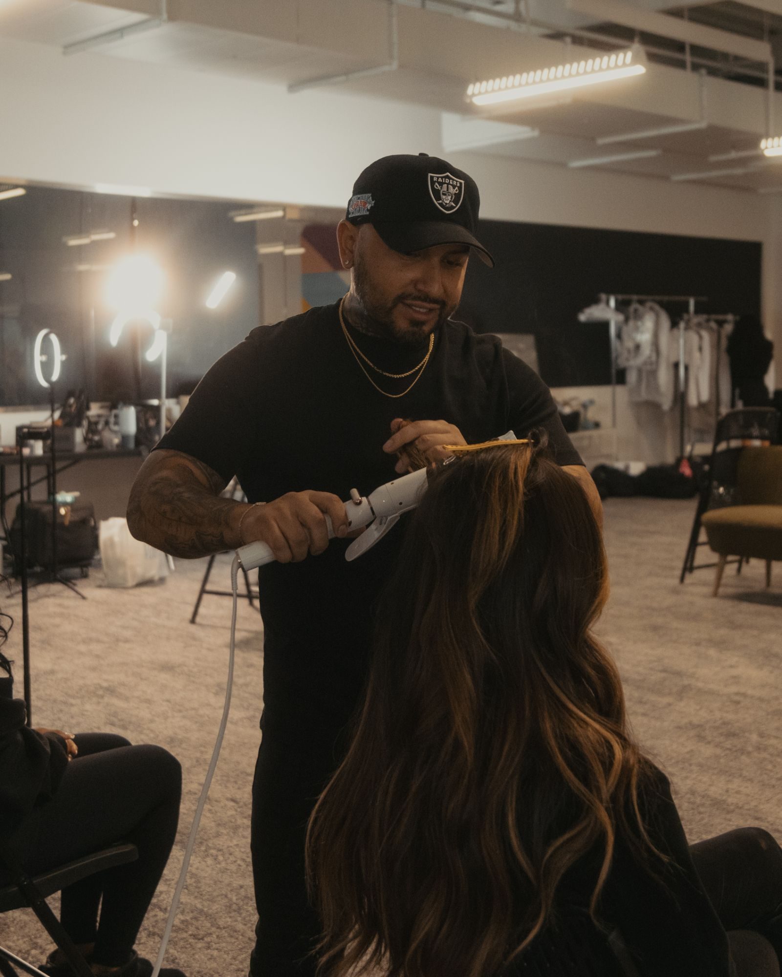 Hair stylist setting curls in the glam room