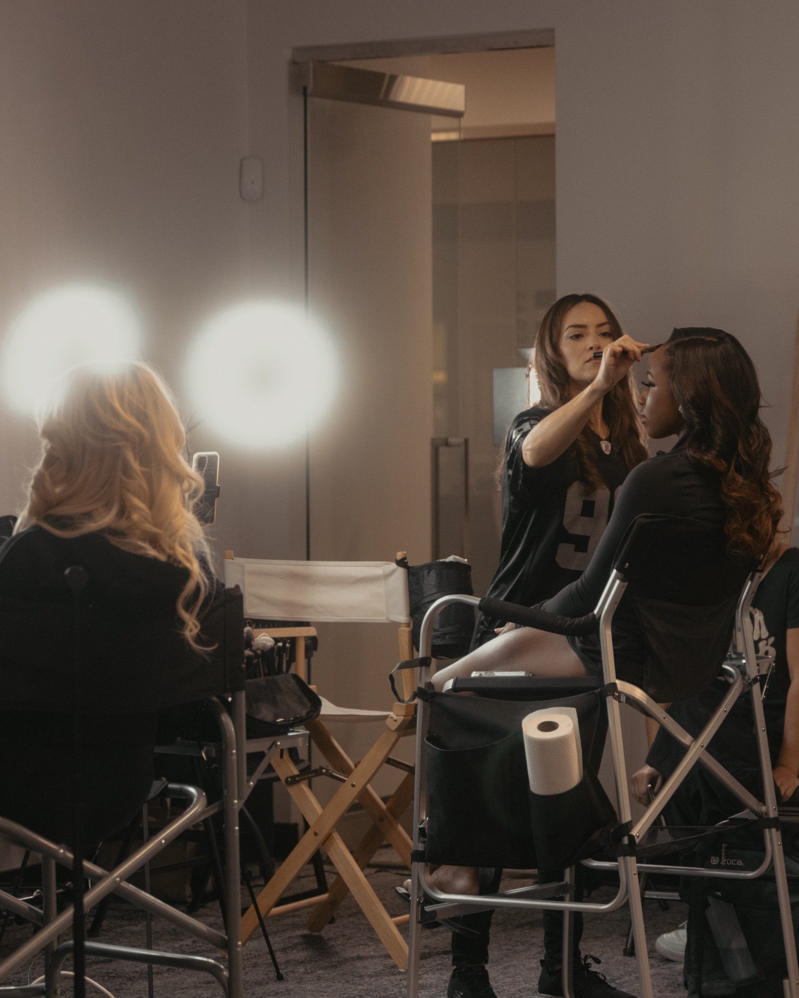 Makeup artist finishing a Raiderette's look